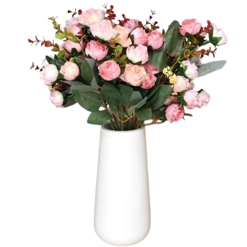 Huitich mini rose flowers arranged in a white vase forming a pink artificial peony bouquet