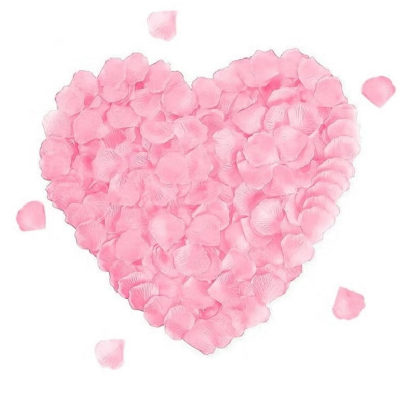 Huitich artificial pink rose petals arranged in a heart shape on white background