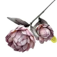Artificial pinkish purple rose stems with clustered petals and dark leaves