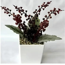 Faux red bonsai branches in a white pot