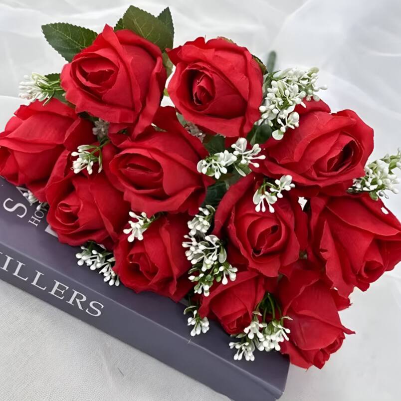 Huitich artificial red flower bouquet with vibrant red roses and white accent flowers on book