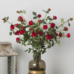 Huitich artificial red rose spray arranged in a decorative glass vase with green leaves