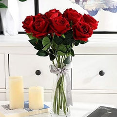 Huitich artificial red rose stem bouquet in clear vase with green leaves displayed on white dresser