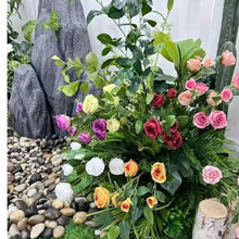 Artificial rose bouquet with mixed-color blooms and green leaves