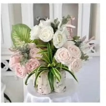 Artificial rose bouquet with white and pale pink blooms in a vase, green foliage