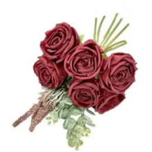 Artificial rose bouquet with burgundy roses, green leaves and faux stems