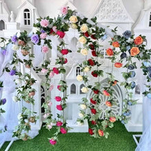Artificial rose wall garland with multicolor blooms and green leaves, hanging decoration