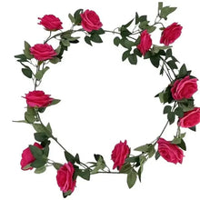 Artificial rose floral garland wreath with pink blooms and green leaves