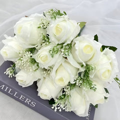 Huitich artificial white flower arrangement with realistic white roses and green foliage on a book