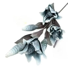 Blue artificial flower decor with ridged white stems and layered petals