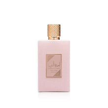 Women’s perfume bottle with rose-pink glass and gold-toned cap