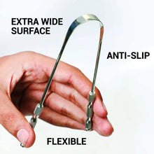 Stainless steel tongue scraper held in hand with wide blade and grip handles