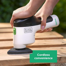 Cordless palm sander in white and black with textured sanding pad under grip