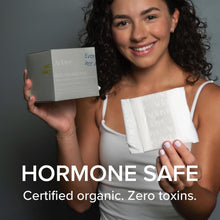 White sanitary pad with wings held by woman, with small product box nearby
