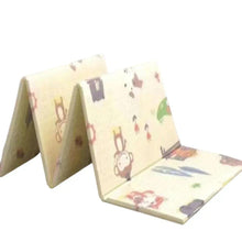Baby play mat with folded panels, light cream surface and colorful animal prints