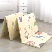 Soft baby activity mat on floor, cream with multicolor bunny and star pattern
