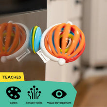 Baby Einstein sticky spinner toy side view with orange outer loops and colored inner rings