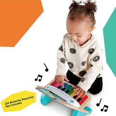 Baby playing with colorful wooden Baby Einstein Magic Touch Piano toy from Huitich