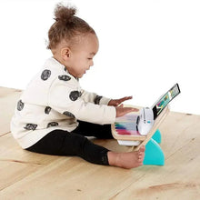 Wooden music toy piano with tablet display on top and rainbow keys on the front