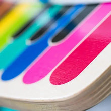 Close-up of rainbow keys on a wooden music toy piano