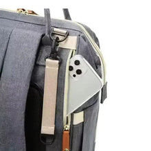Gray diaper backpack side pocket with white phone compartment, webbing strap and zipper