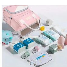 Pink baby travel backpack with open interior and accessories inside