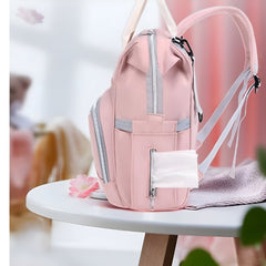 Mum's baby travel backpack pink with multiple zippered compartments and tissue dispenser pocket