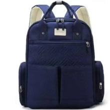Navy baby travel bag with front zipper, quilted panel, and side carry pocket