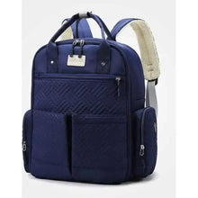 Navy quilted baby travel bag with dual handles and front zip pockets