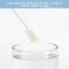 Ccy baby oral cleaner for infants white foam brush on handle being dipped into a glass of water
