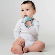 Baby holding a blue silicone animal teether ring with textured top nubs