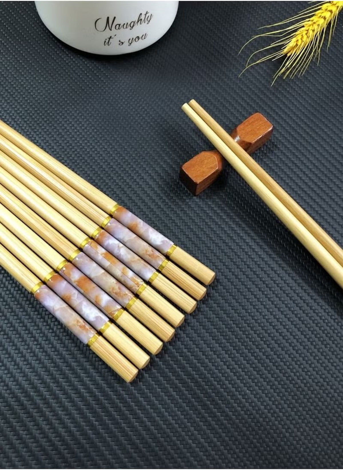 Huitich bamboo chopsticks reusable set with decorative accents and wooden chopstick holders on black surface