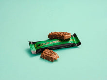 Two hazelnut & nougat protein bars in green-and-black wrappers