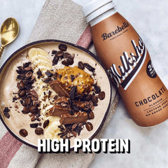 Barebells protein milkshake UAE chocolate bottle beside banana chocolate smoothie bowl topped with peanut butter and coffee beans