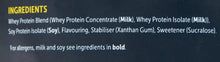 Whey protein ingredients list panel on the back of a dark foil pouch