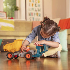 Child playing with Battat dump truck toy for kids featuring a yellow bed and orange wheels indoors
