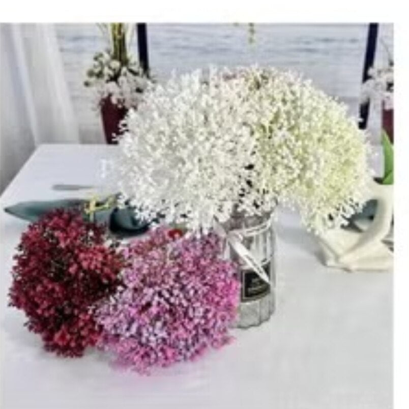 Huitich beige artificial flower decor with white, pink, and red floral arrangements on a white table