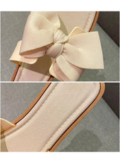 Close-up of huitich beige bowknot wedge flip flops with cushioned footbed and decorative bow detail