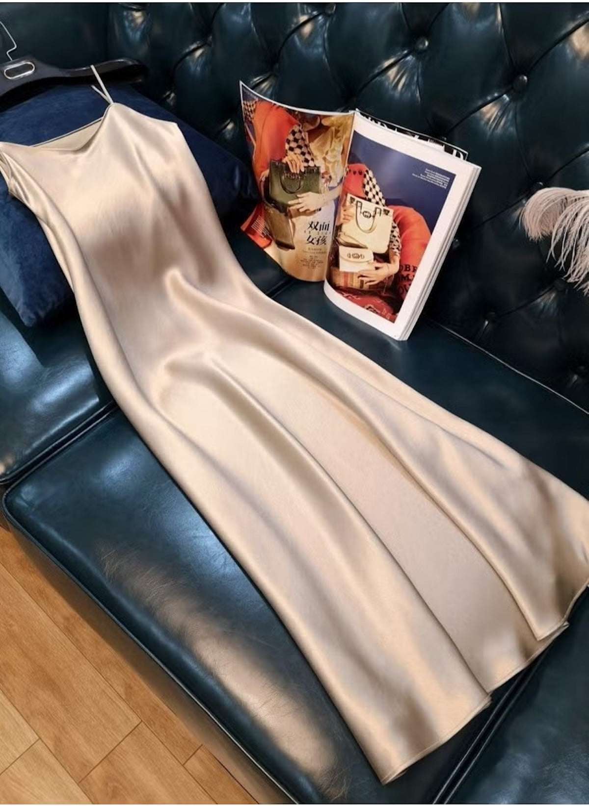 Huitich beige sleeveless satin dress XL laid out on dark green leather sofa with magazine