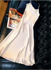 Huitich beige sleeveless satin dress XL laid out on black leather sofa with a magazine