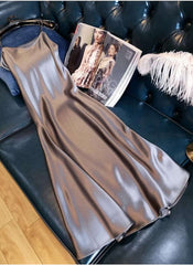 Huitich beige sleeveless satin dress XL laid out on dark leather couch next to fashion magazine