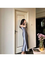 Huitich beige sleeveless satin dress XL worn by a woman standing near a door indoors