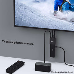 BENFEI HDMI to VGA adapter with audio connected to TV and TV stick showing snowboarding scene