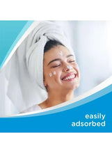 Skincare cream on face, towel wrap