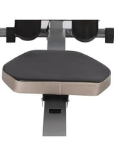 Padded rowing seat with black top and beige sides on a silver frame