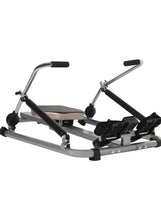 Compact rowing machine with black footrests, seat, and silver base frame