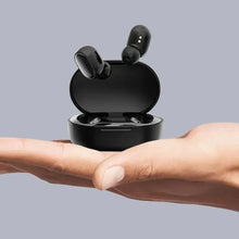 Gaming true wireless earbuds, black earbuds standing in open charging case