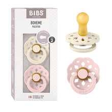 Round pacifier 2-pack with ivory and pink shields, yellow and pink button details