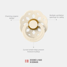 Ivory round pacifier with ventilated shield and curved shield ring