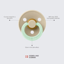 Light beige pacifier with mint shield and round nipple, glow-in-the-dark effect